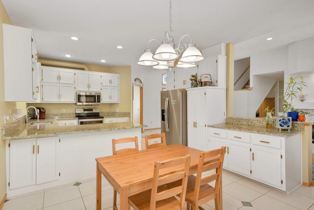 12625 Tiffany Ct, Burnsville, MN 55337 - kitchen featuring stainless steel appliances, a peninsula, a sink, recessed lighting, and light tile patterned floors