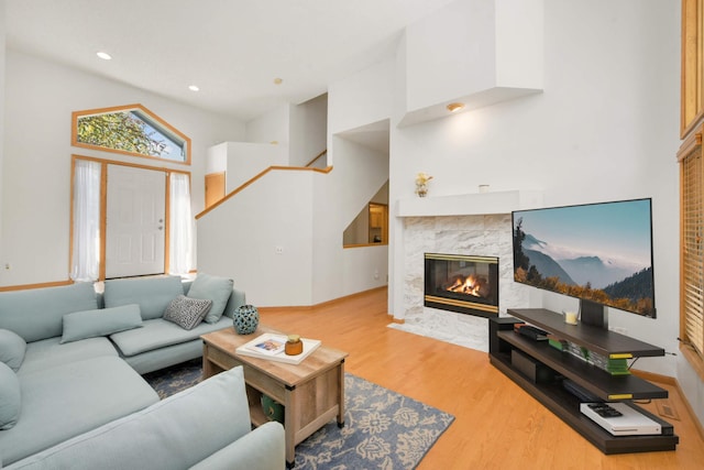 12625 Tiffany Ct, Burnsville, MN 55337 - living room with a tile fireplace, wood finished floors, a high ceiling, and baseboards