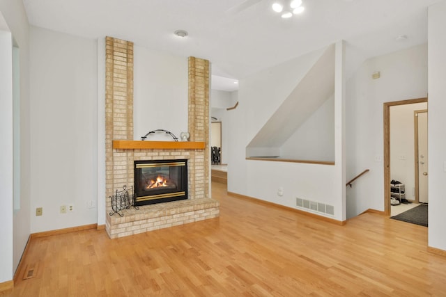12625 Tiffany Ct, Burnsville, MN 55337 - unfurnished living room featuring wood finished floors, a brick fireplace, and baseboards