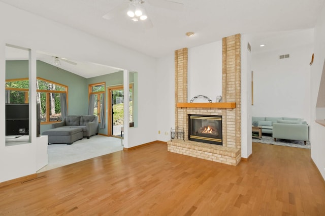 12625 Tiffany Ct, Burnsville, MN 55337 - living area with a ceiling fan, wood finished floors, a brick fireplace, and baseboards