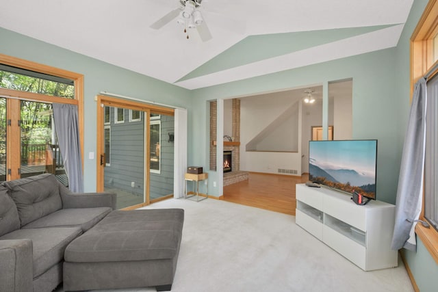 12625 Tiffany Ct, Burnsville, MN 55337 - living area featuring vaulted ceiling, a ceiling fan, a fireplace, light colored carpet, and baseboards