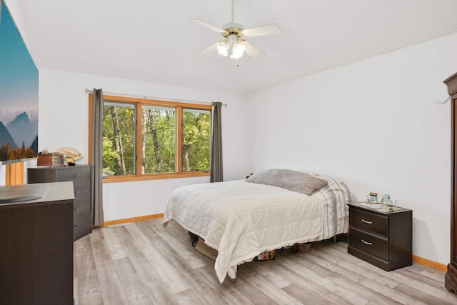 12625 Tiffany Ct, Burnsville, MN 55337 - bedroom featuring baseboards, light wood finished floors, and a ceiling fan
