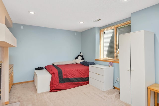 12625 Tiffany Ct, Burnsville, MN 55337 - bedroom with light colored carpet, a glass covered fireplace, baseboards, and recessed lighting
