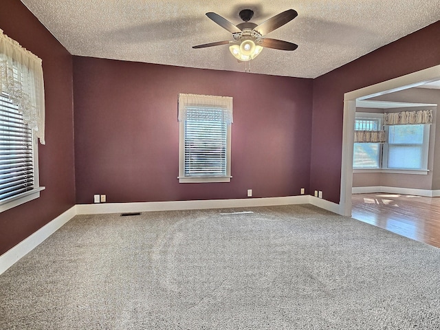 1501 Park St, Fairmont, MN 56031 - unfurnished room featuring carpet flooring, a ceiling fan, a textured ceiling, and baseboards