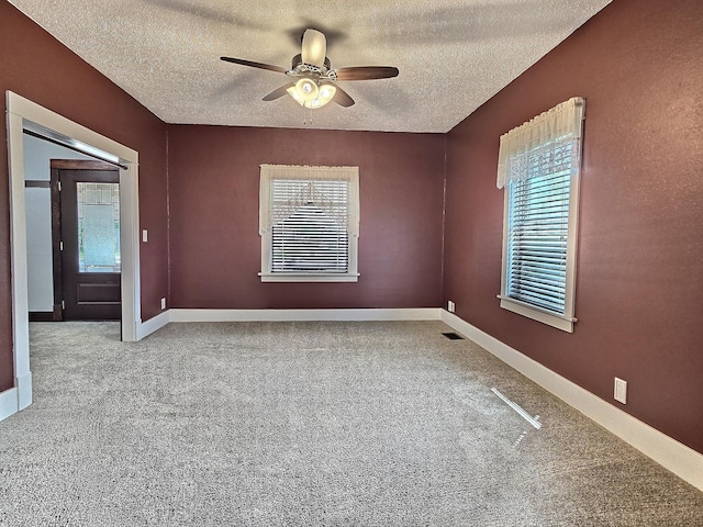 1501 Park St, Fairmont, MN 56031 - carpeted spare room with a ceiling fan, a textured ceiling, and baseboards