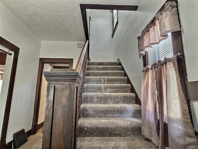1501 Park St, Fairmont, MN 56031 - stairs with a textured wall, carpet flooring, baseboards, and a textured ceiling