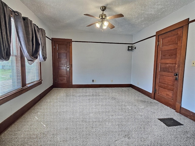 1501 Park St, Fairmont, MN 56031 - unfurnished room featuring a textured ceiling, a ceiling fan, carpet floors, and baseboards