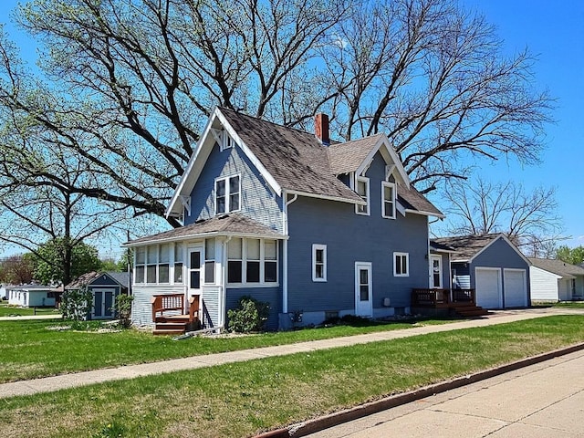 1501 Park St, Fairmont, MN 56031 - view of home's exterior featuring a chimney, a yard, concrete driveway, and roof with shingles