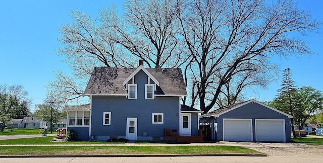 1501 Park St, Fairmont, MN 56031 - view of front of home featuring a detached garage, a front yard, an outdoor structure, and a shingled roof