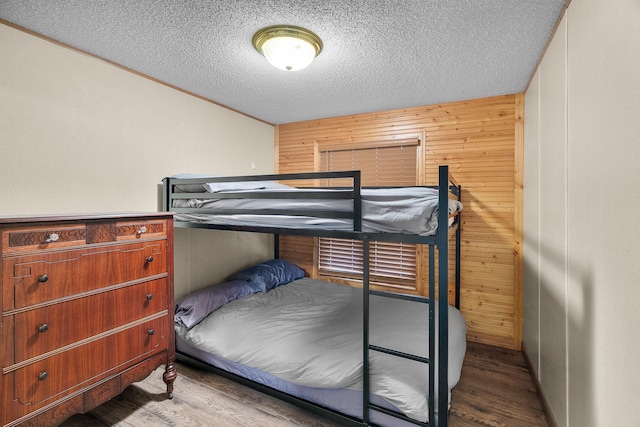 1651 Niles Ln N, Centuria, WI 54824 - bedroom featuring wood finished floors, a textured ceiling, and wood walls