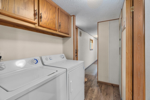 1651 Niles Ln N, Centuria, WI 54824 - laundry room featuring cabinet space, wood finished floors, washer and dryer, and a textured ceiling