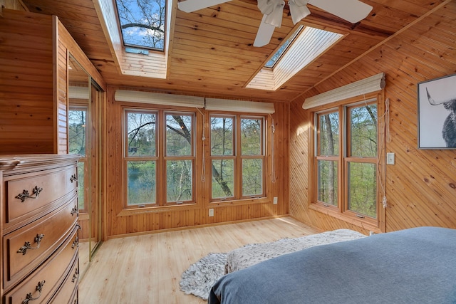 1651 Niles Ln N, Centuria, WI 54824 - bedroom with a skylight, light wood-style flooring, wood walls, vaulted ceiling, and wooden ceiling