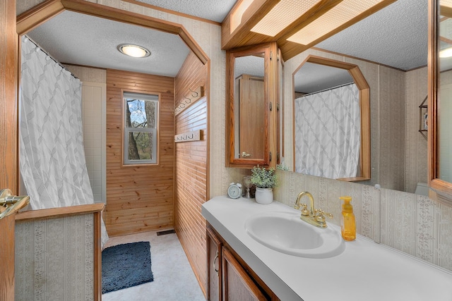 1651 Niles Ln N, Centuria, WI 54824 - bathroom featuring a textured ceiling, wallpapered walls, vanity, and crown molding