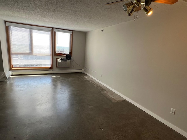 unfurnished room featuring a baseboard radiator, a ceiling fan, a textured ceiling, concrete floors, and baseboards