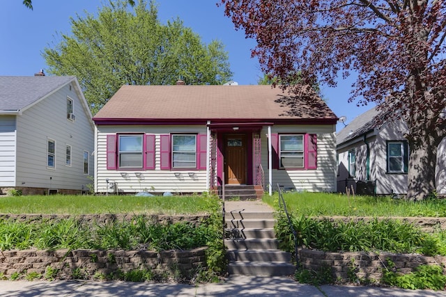 bungalow-style house with a shingled roof