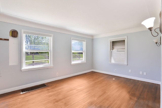 unfurnished room with wood finished floors and baseboards