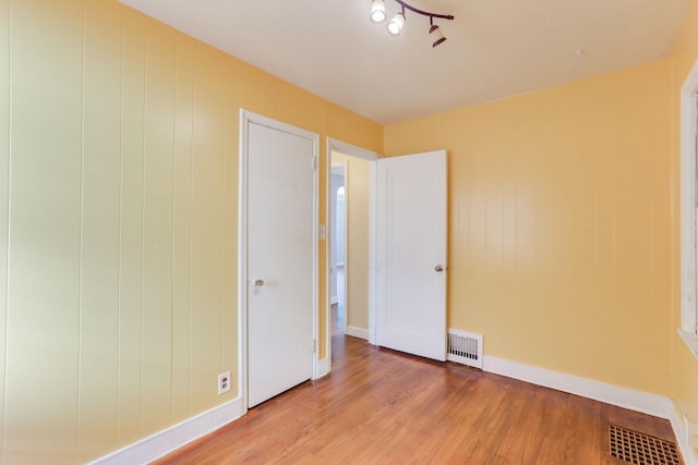 unfurnished bedroom with light wood-style floors and baseboards