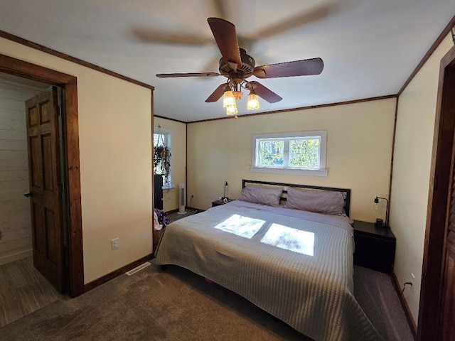 bedroom featuring carpet floors, baseboards, ornamental molding, and a ceiling fan