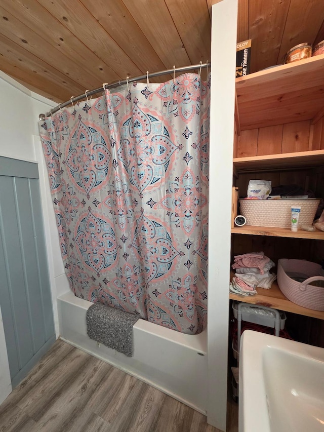 full bathroom featuring wood finished floors, shower / bath combo, and wood ceiling