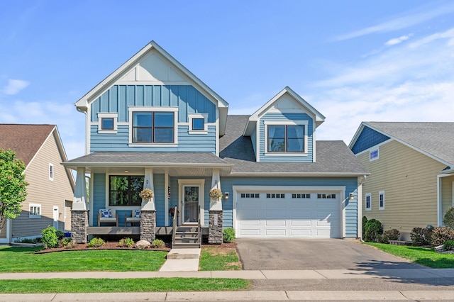 craftsman-style house featuring board and batten siding, driveway, a porch, an attached garage, and a shingled roof