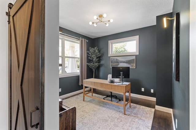 office with wood finished floors, a chandelier, baseboards, and a textured ceiling