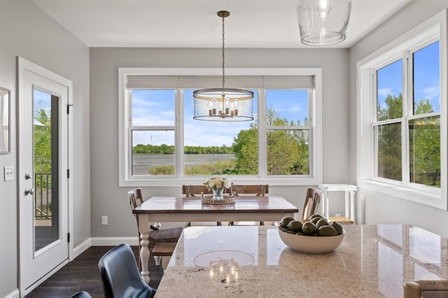 dining room with a chandelier, dark wood-style floors, and plenty of natural light