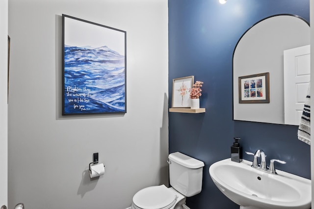 half bath with a sink and toilet