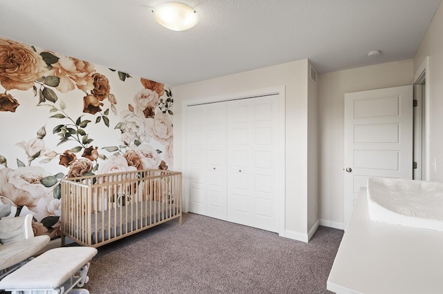 carpeted bedroom featuring a closet and baseboards
