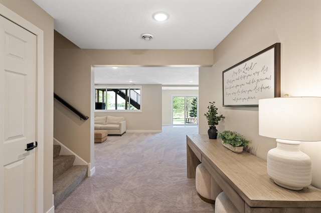 hall with light colored carpet, stairway, baseboards, and recessed lighting