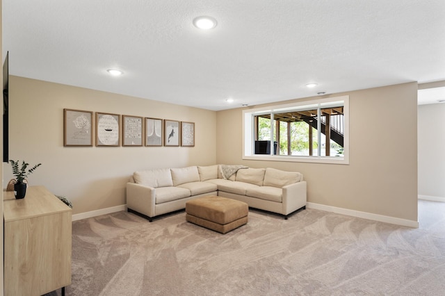 carpeted living area with recessed lighting and baseboards