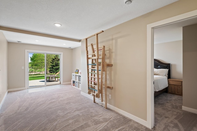 hallway with carpet flooring, baseboards, a textured ceiling, and recessed lighting