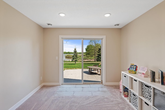 entryway with light colored carpet, baseboards, and recessed lighting