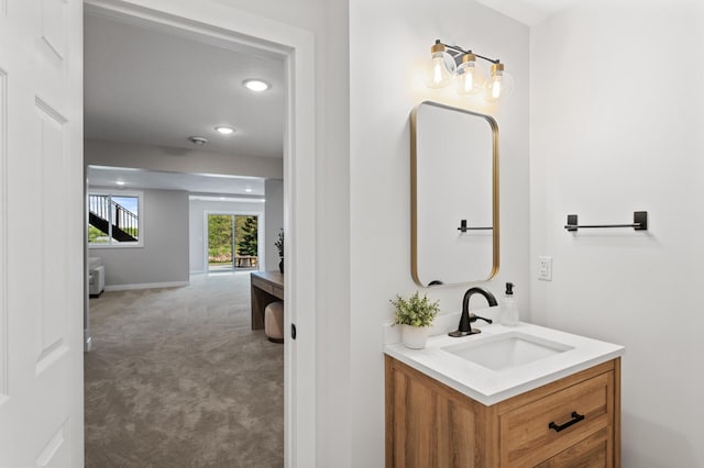 bathroom with vanity, recessed lighting, and baseboards