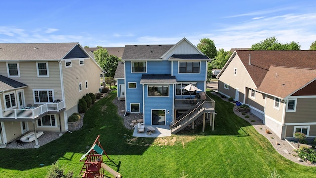 back of house with a patio area, board and batten siding, a residential view, and a yard