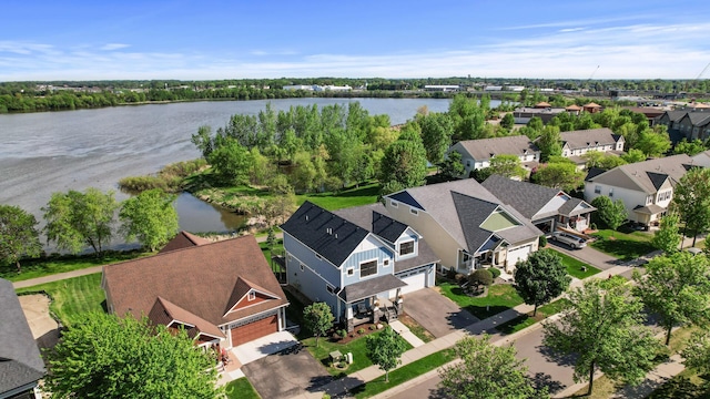 aerial view of residential area featuring a nearby body of water