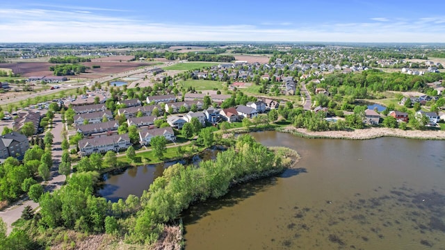 aerial view of property's location with a large body of water and nearby suburban area