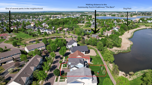 aerial perspective of suburban area with property boundaries highlighted and a nearby body of water