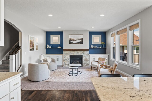 6644 Lamplight Dr, Albertville, MN 55301 - living area with dark wood-type flooring, stairway, recessed lighting, baseboards, and a fireplace