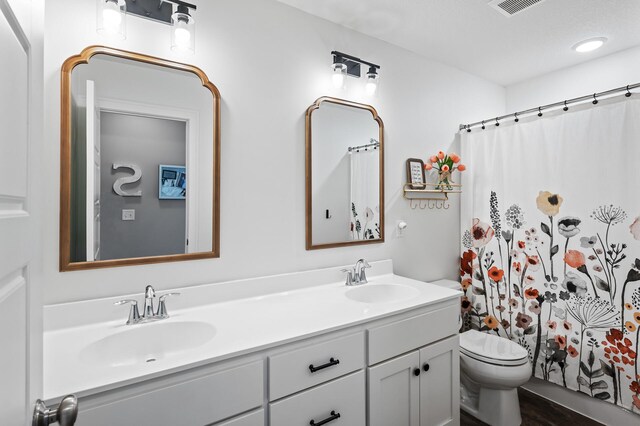 6644 Lamplight Dr, Albertville, MN 55301 - full bath featuring double vanity, toilet, and a shower with shower curtain