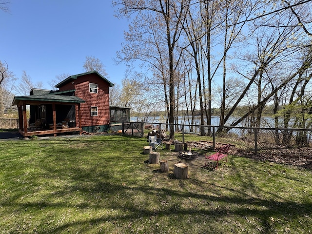 view of yard with a deck with water view
