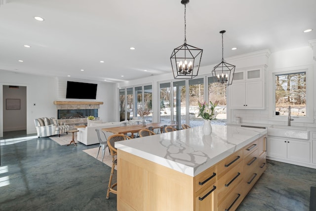 4898 County Road 6, Independence, MN 55359 - kitchen featuring a sink, a large fireplace, a chandelier, a kitchen island, and recessed lighting