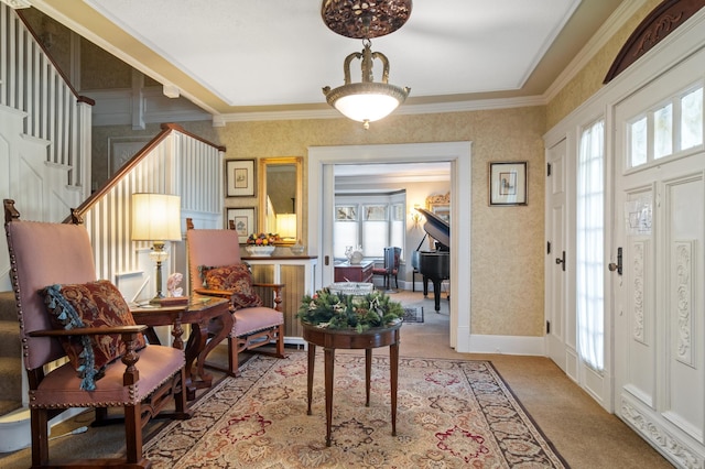 carpeted entrance foyer with wallpapered walls and crown molding