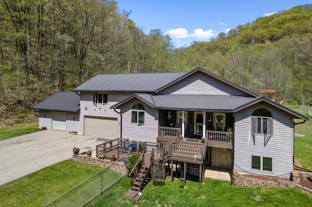 23677 County Road 23, Winona, MN 55987 - view of front of home with driveway, a front lawn, a porch, and metal roof