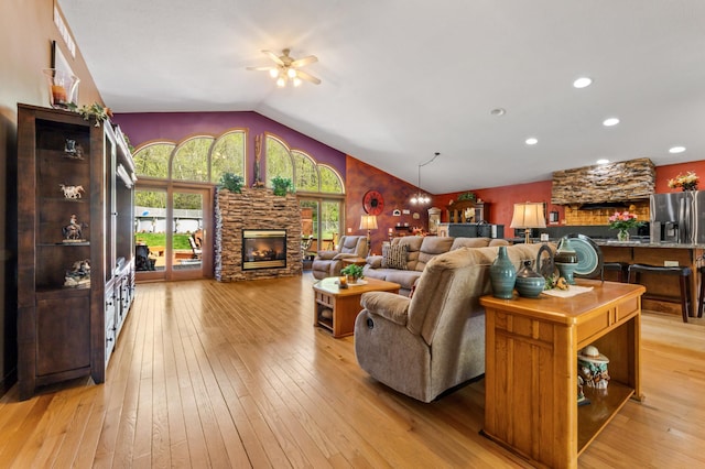 23677 County Road 23, Winona, MN 55987 - living room with a ceiling fan, light wood finished floors, lofted ceiling, and a stone fireplace