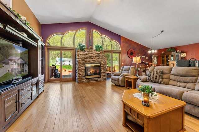 23677 County Road 23, Winona, MN 55987 - living area featuring lofted ceiling, a stone fireplace, and light wood-style floors