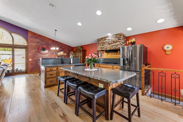 23677 County Road 23, Winona, MN 55987 - kitchen featuring stainless steel fridge, lofted ceiling, dark countertops, light wood-type flooring, and a kitchen island