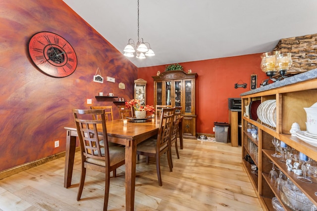 23677 County Road 23, Winona, MN 55987 - dining area featuring a chandelier, light wood-type flooring, and lofted ceiling
