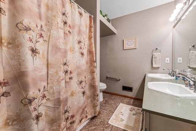 23677 County Road 23, Winona, MN 55987 - bathroom featuring double vanity, toilet, baseboards, and curtained shower