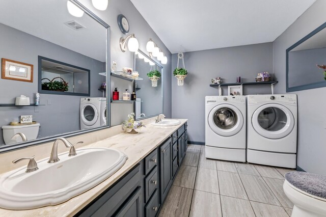 23677 County Road 23, Winona, MN 55987 - full bathroom featuring washer and clothes dryer, toilet, and double vanity