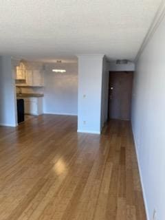 7412 22nd St Unit 204, Saint Louis Park, MN 55426 - unfurnished living room featuring crown molding, wood finished floors, and baseboards